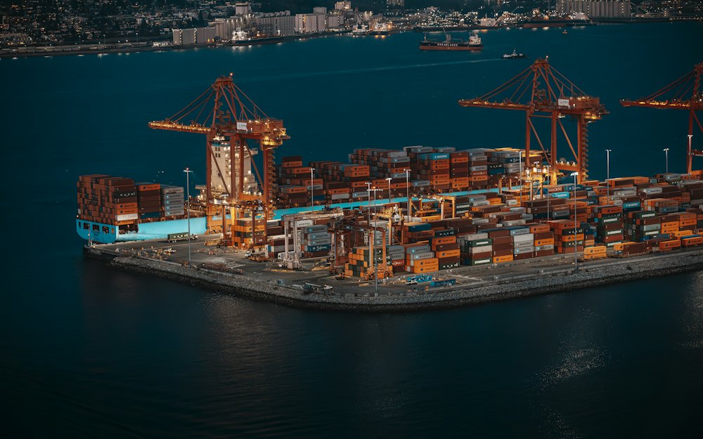 Container ship being worked by cranes at a busy port