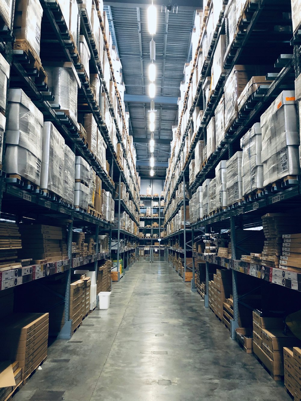 Tall warehouse racking stacked with pallets